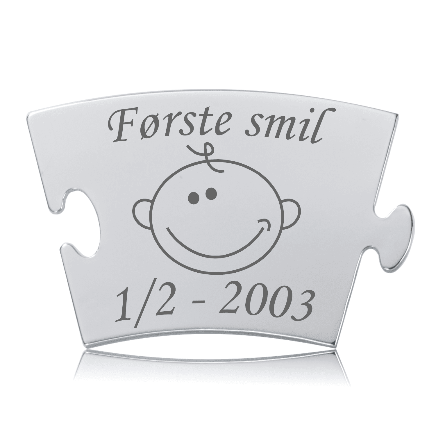 Første smil Memozz Classic Brik Memozz Classic brik med gravering af "Første smil" og et smilende babyansigt, i poleret rustfrit stål