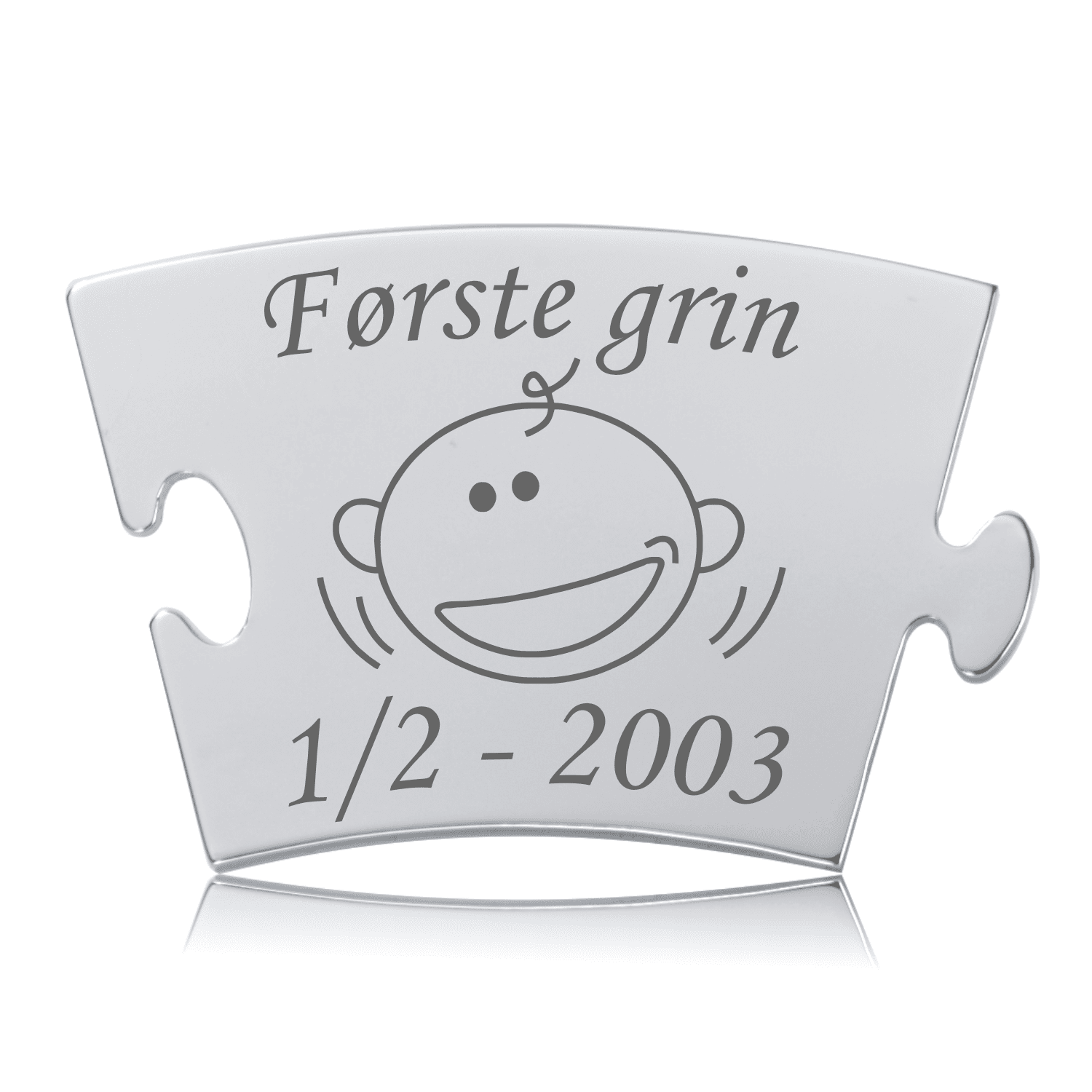 Memozz Classic brik "Første grin" i håndpoleret rustfri stål med lasergravering af en glad babyfigur
