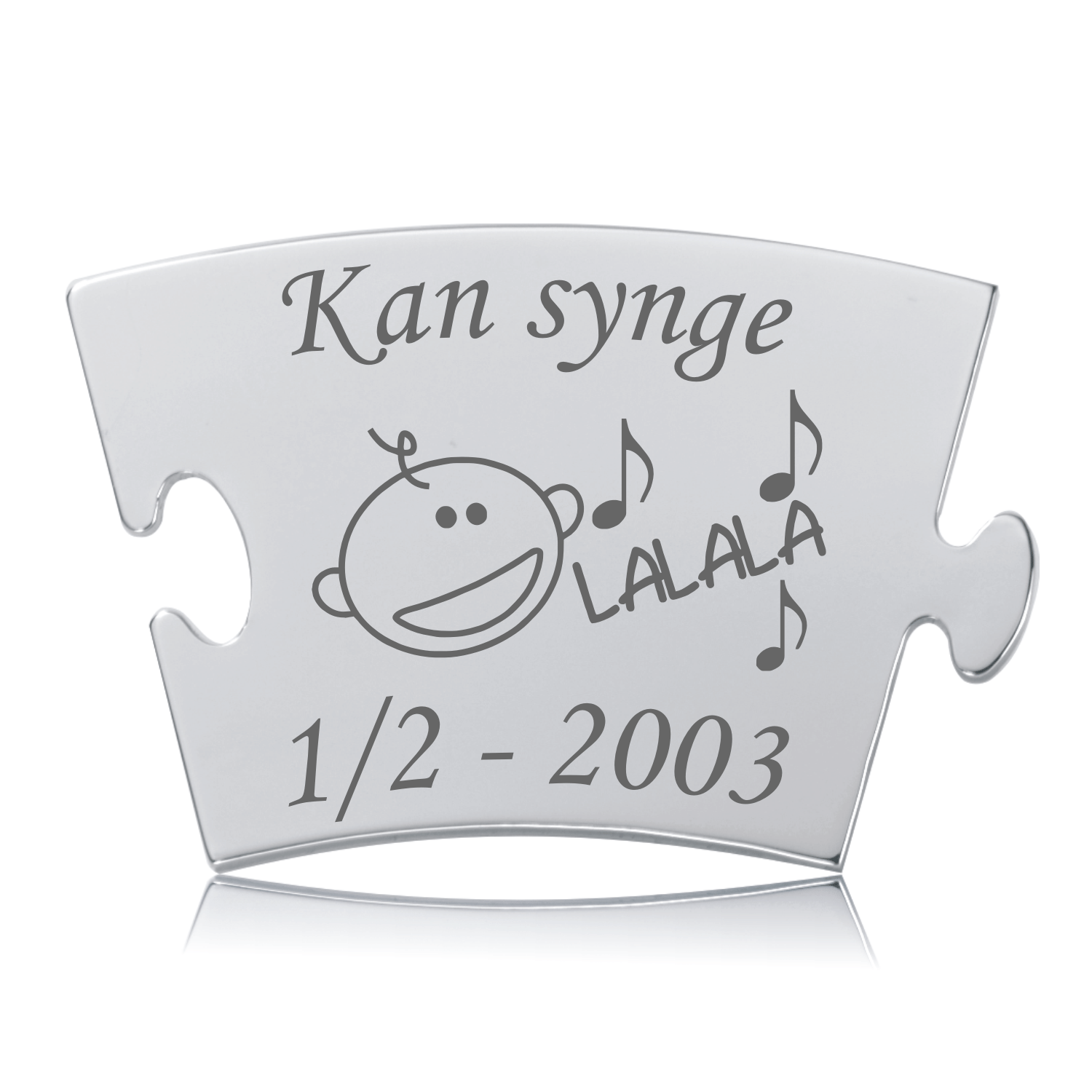 Kan synge - Memozz Classic brik Memozz Classic brik "Kan synge" i blankpoleret stål med lasergravering af en glad figur og musiknoder.