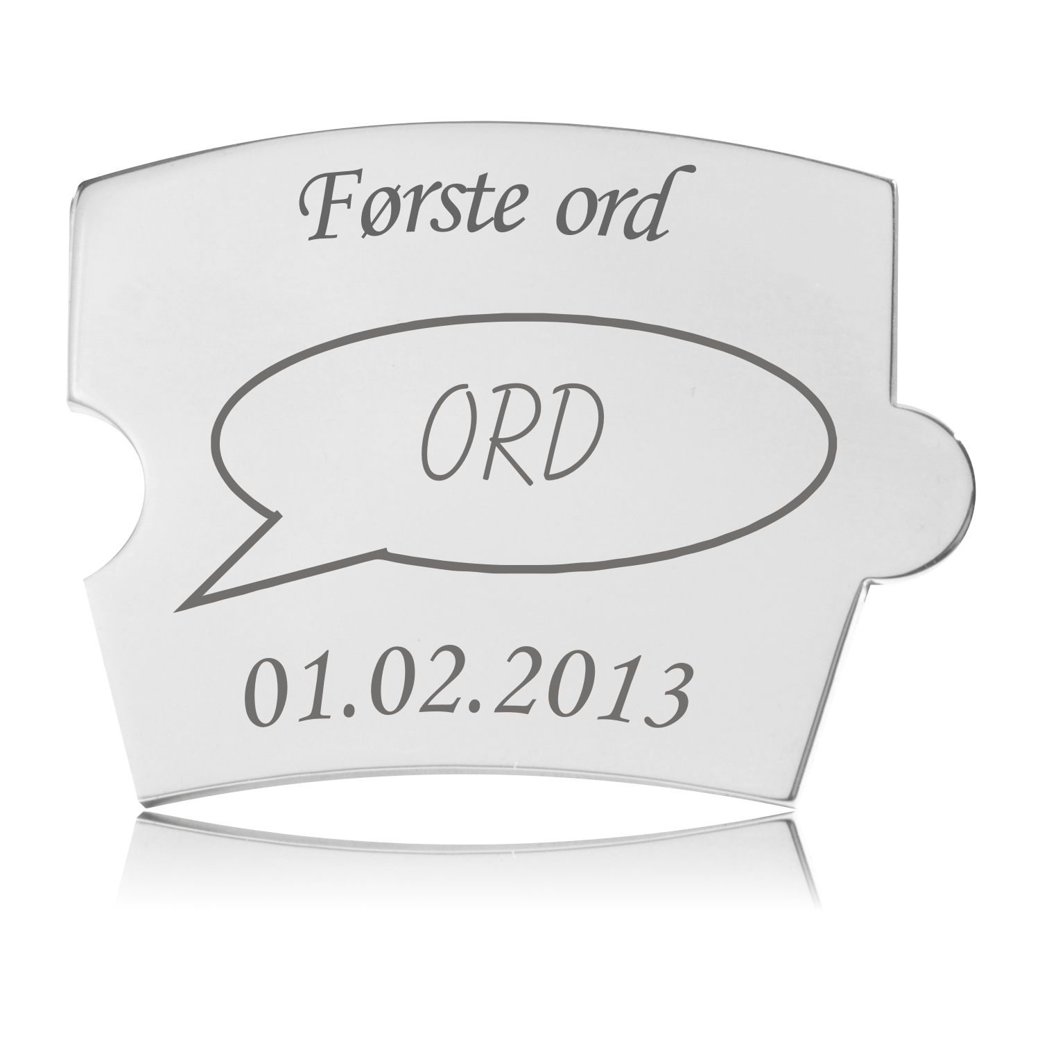 Memozz Spin brik i rustfrit stål med teksten "Første ord" og en tankeboble med "ORD" graveret