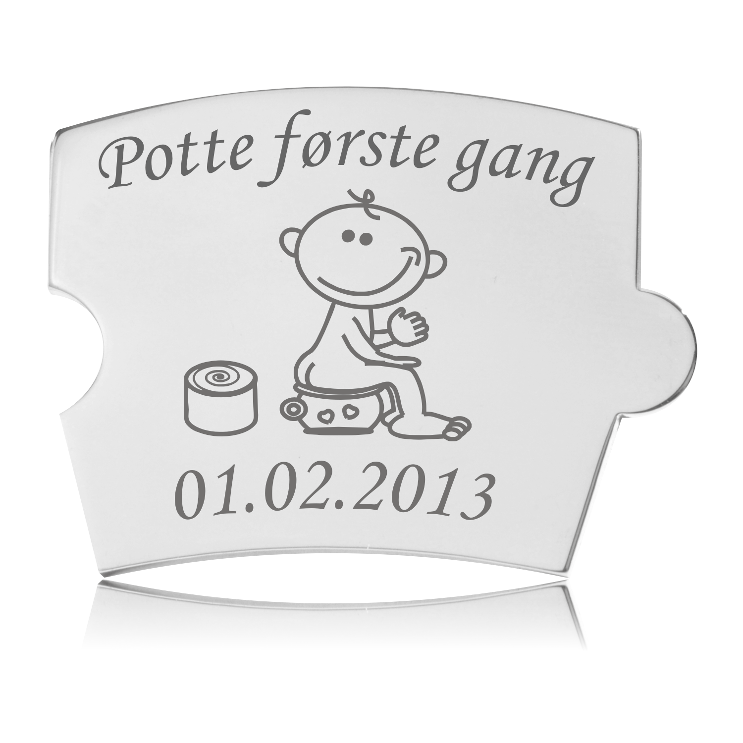Memozz Spin brik i håndpoleret rustfrit stål med gravering af et barn på potte og teksten "Potte første gang".