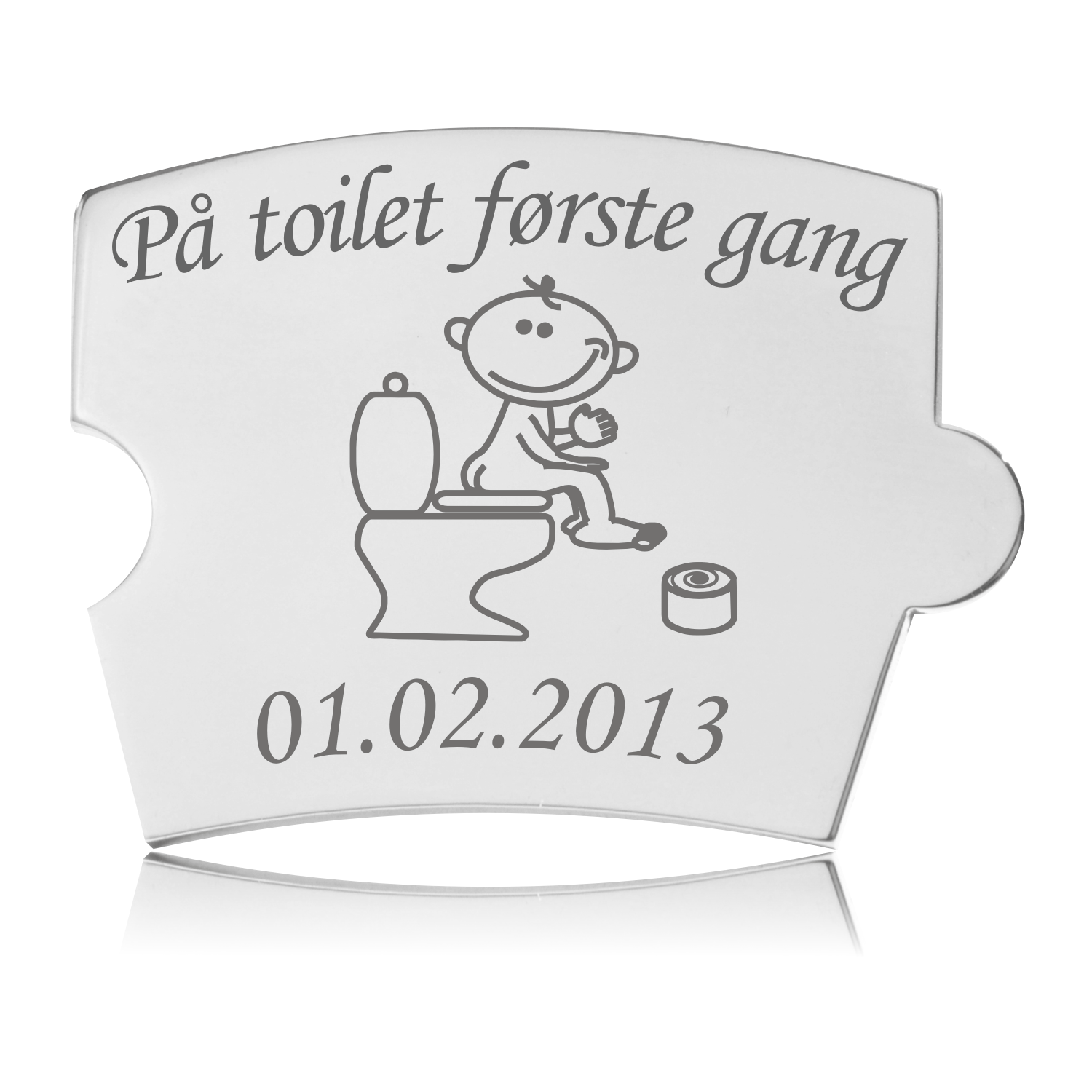 Memozz Spin brik i håndpoleret rustfrit stål med gravering af et barn på toilet og teksten "På toilet første gang".