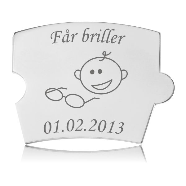 Memozz Spin brik i rustfrit stål med gravering af 'Får briller' og tegning af et barneansigt med briller.