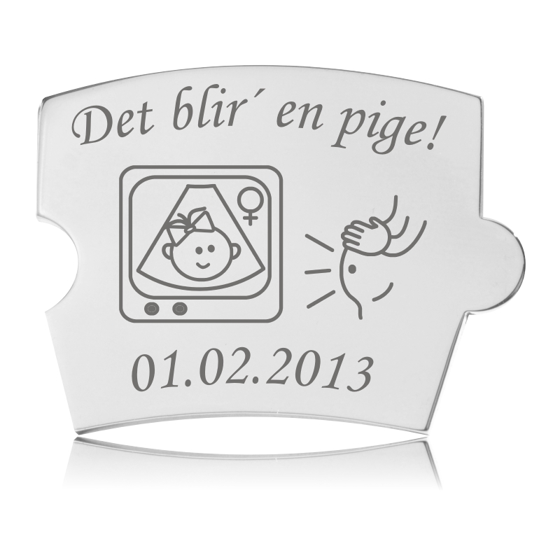 Memozz Spin brik i poleret stål med gravering af 'Det blir' en pige!', ultralydsbillede af pige, og en gravid mave.