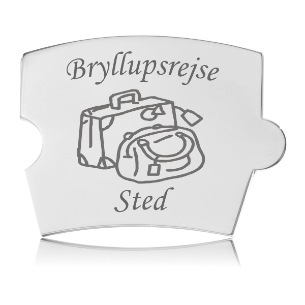 Memozz Spin brik i håndpoleret rustfrit stål med gravering af en kuffert og en taske, samt teksten "Bryllupsrejse" og "Sted".